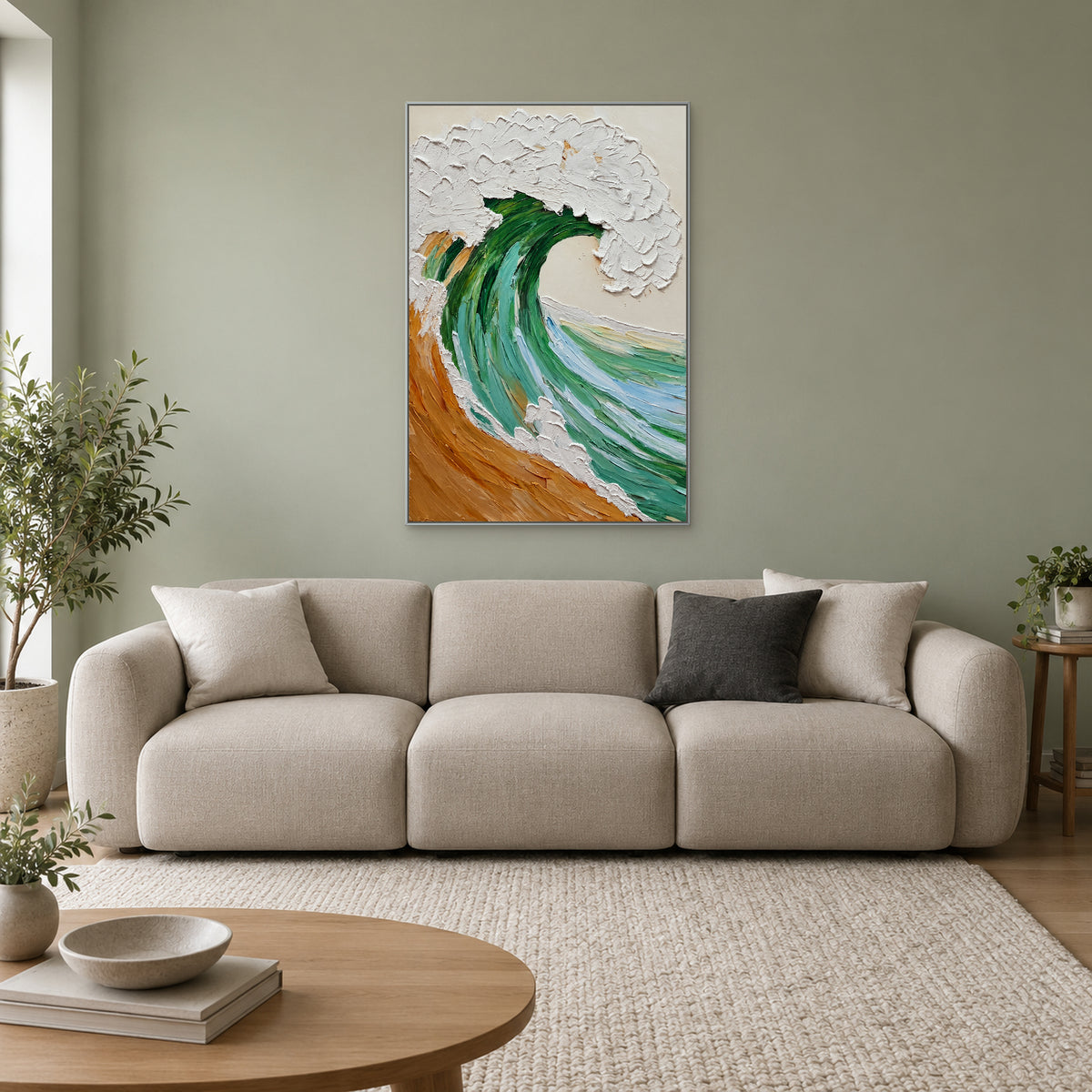 Raised white wave crest and green water in a silver-tone frame above a cream sofa on a sage wall