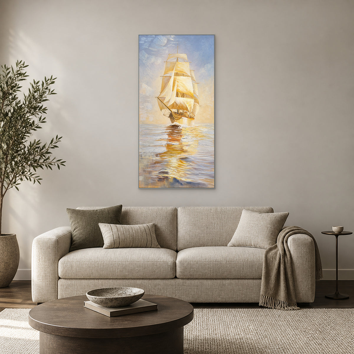 Tall sailing ship painting in a silver-coloured floating frame above an oatmeal sofa on a warm greige wall.