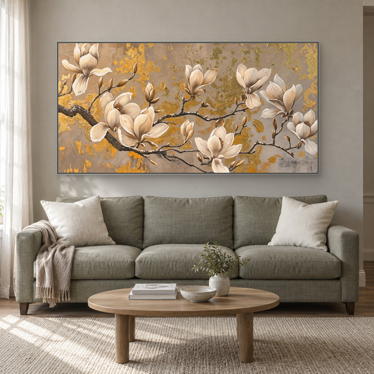 Ivory blooms and gold-toned texture in a slim silver-coloured frame above a muted green sofa