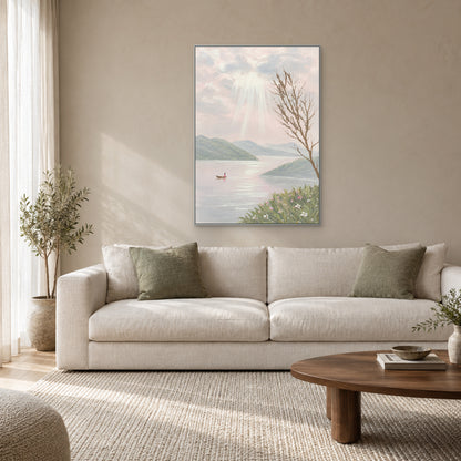 Vertical lake and mountain artwork in a silver-tone frame above a light fabric sofa