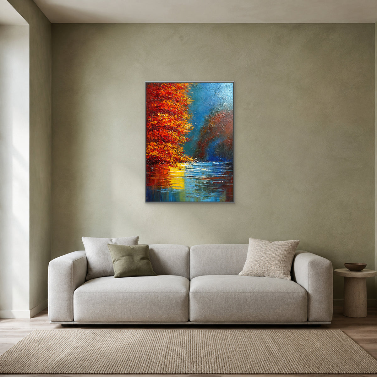 Vertical autumn landscape in a slim silver floating frame centred above a pale grey sofa