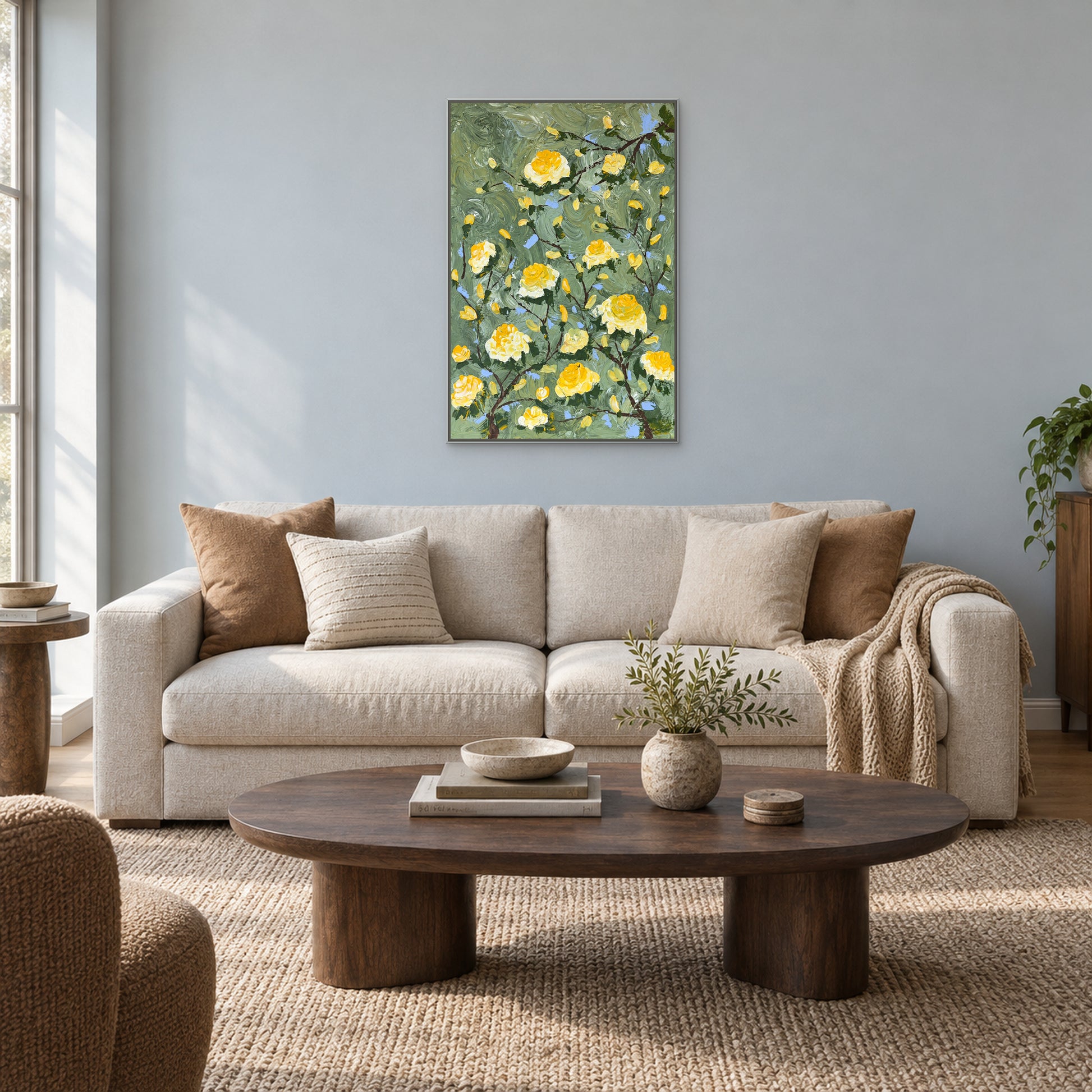 Vertical rose painting in a silver-tone floating frame above an oatmeal sofa on a pale blue-grey wall