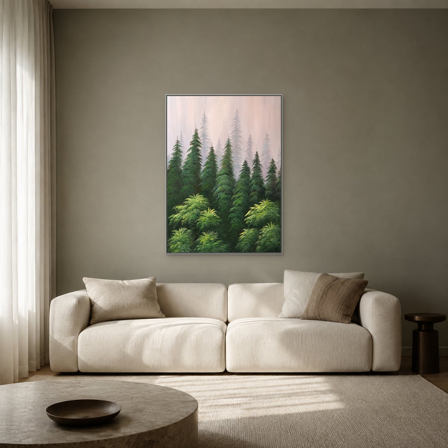 Misty pine forest painting in a slim silver floating frame above a cream sofa on a muted sage-grey wall