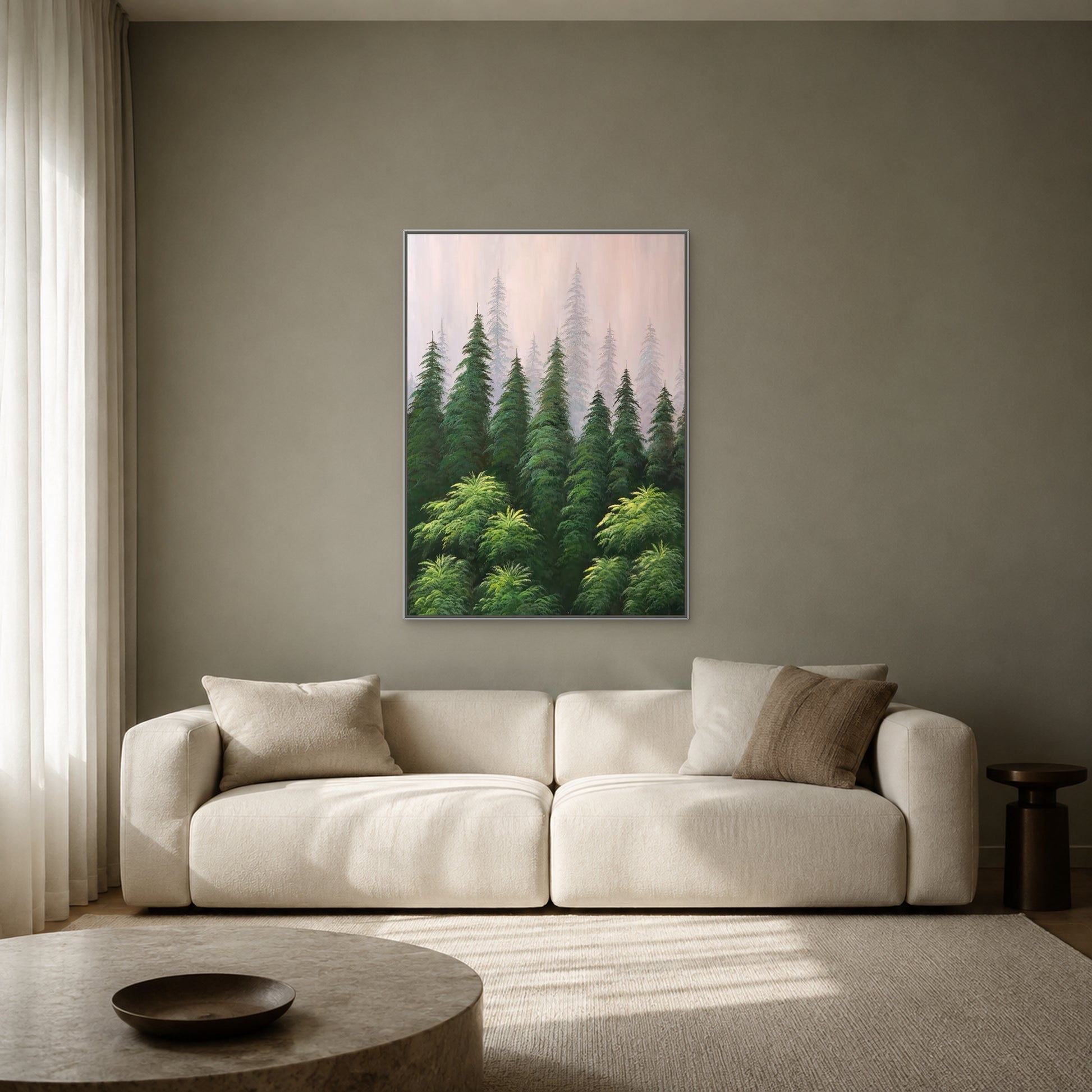 Misty pine forest painting in a slim silver floating frame above a cream sofa on a muted sage-grey wall