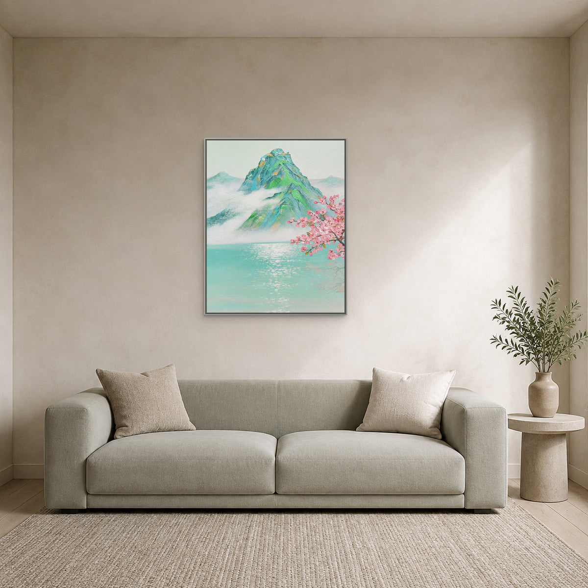Vertical jade mountain painting in a slim silver floating frame above a pale sofa