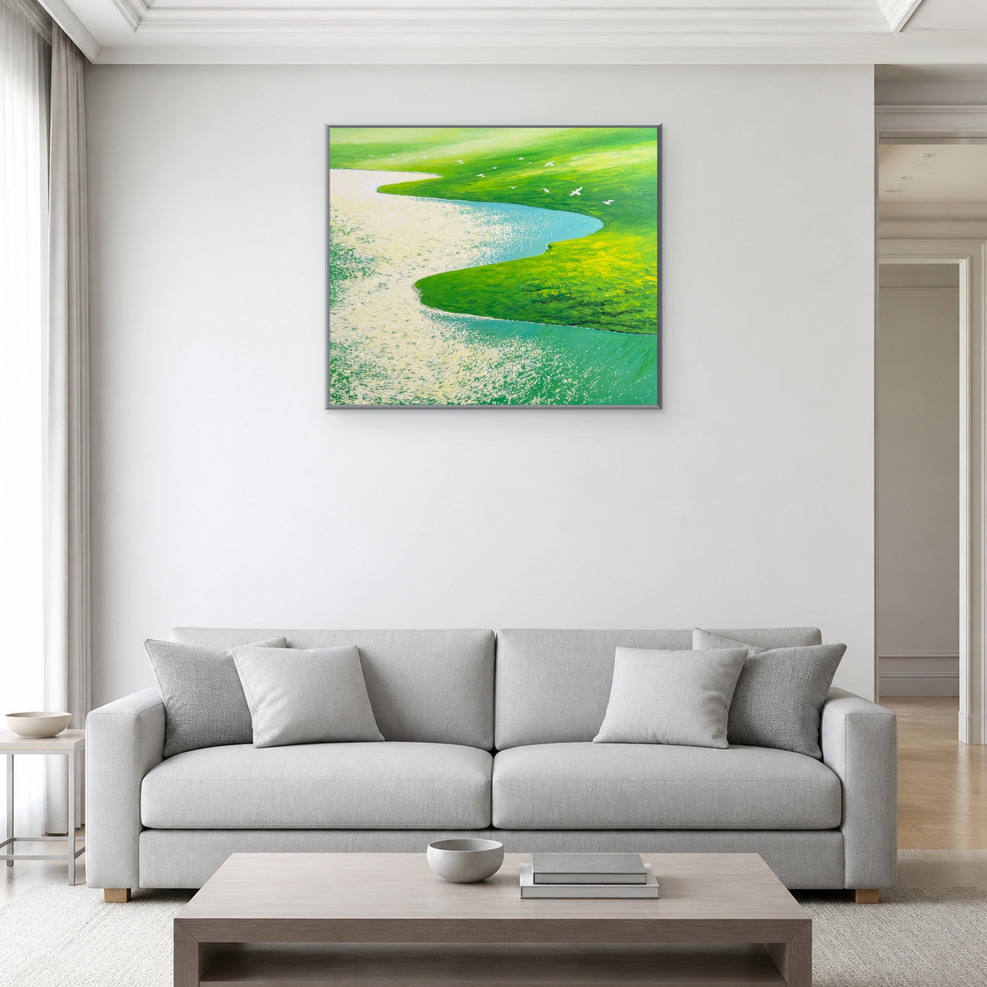 Flight Over Green Meadows in a slim silver floating frame above a light grey living room sofa