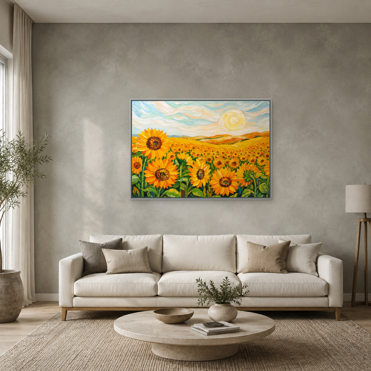 Sunflower field painting in a slim silver floating frame above a cream sofa on a muted sage-grey wall