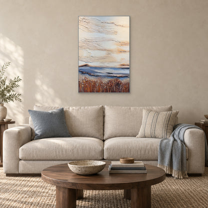 Pale textured abstract in a silver-coloured frame above an ivory sofa with dusty-blue cushions
