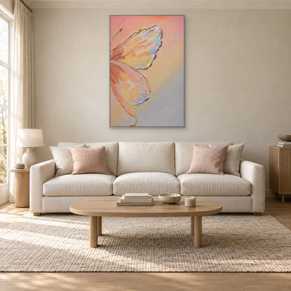 Pastel butterfly in a silver-tone floating frame centred above a cream sofa
