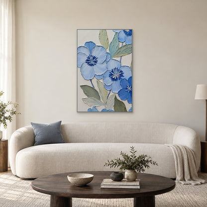 Blue floral relief in a slim silver-tone frame centred above a curved cream sofa