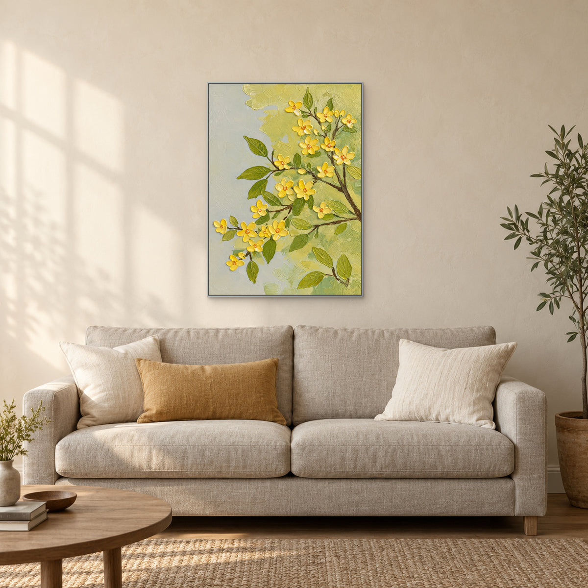 Silver-tone framed floral painting above a cream sofa with an ochre cushion and a low wooden table