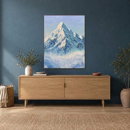 Textured snow peak painting in a walnut-look frame above an oak-coloured console against a deep teal wall.