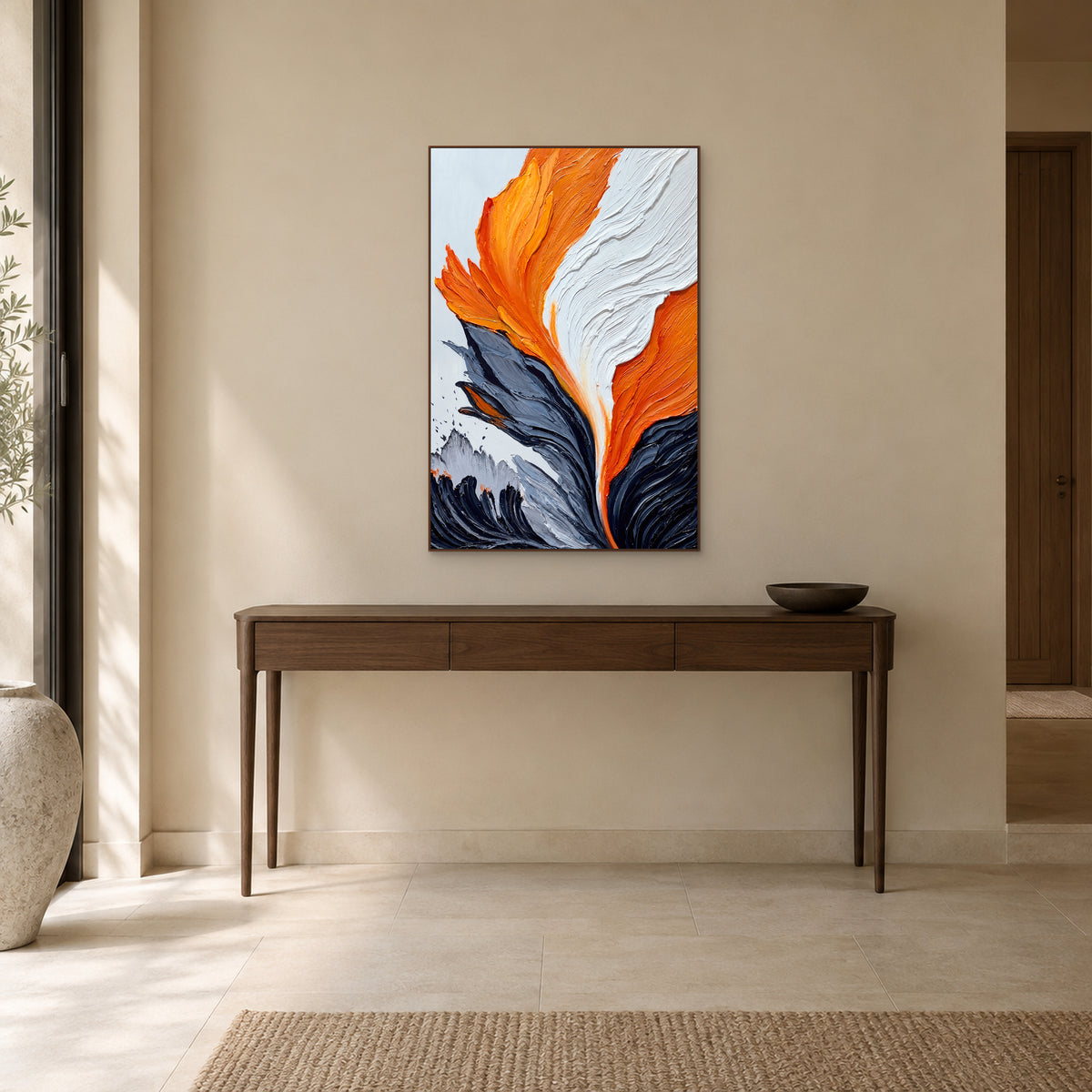 Orange abstract painting in a walnut-tone floating frame above a wooden entryway console