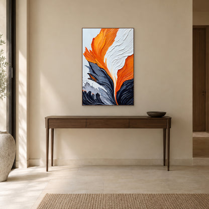 Orange abstract painting in a walnut-tone floating frame above a wooden entryway console