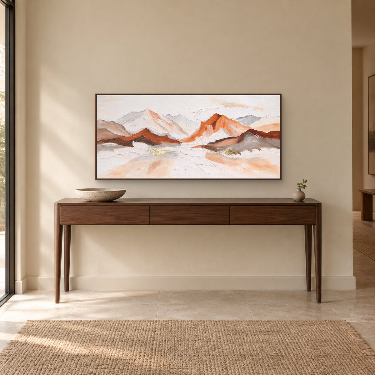 Panoramic mountain painting in a walnut-tone floating frame centred above a wooden entryway console