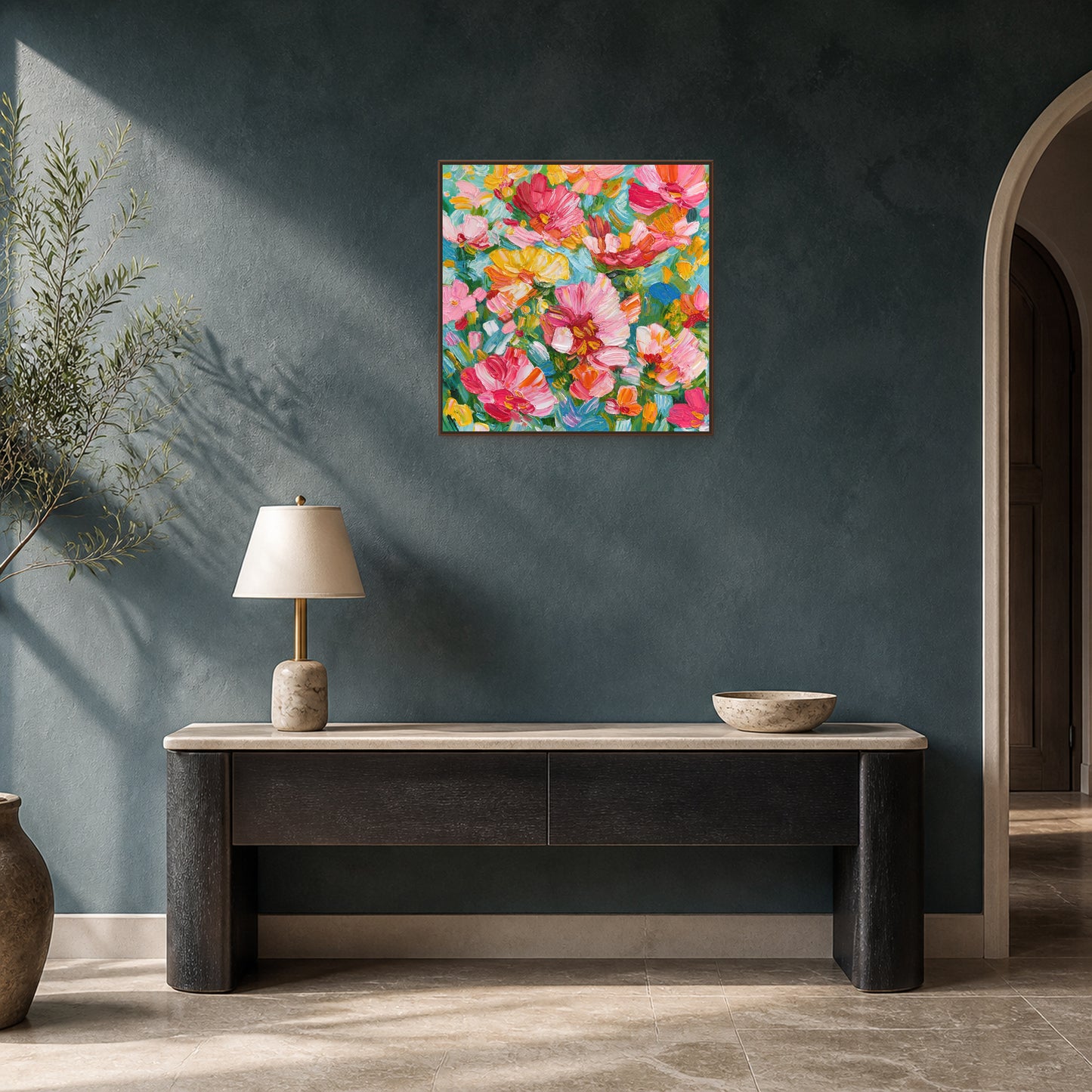 Floral Abundance in a slim walnut floating frame above a dark oak console on a deep blue-green entryway wall