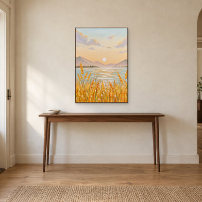 Golden grain and lake artwork in a walnut-tone frame above a slender entryway console