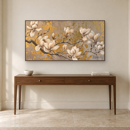 Magnolia branch wall art in a walnut-toned frame above a wooden entryway console