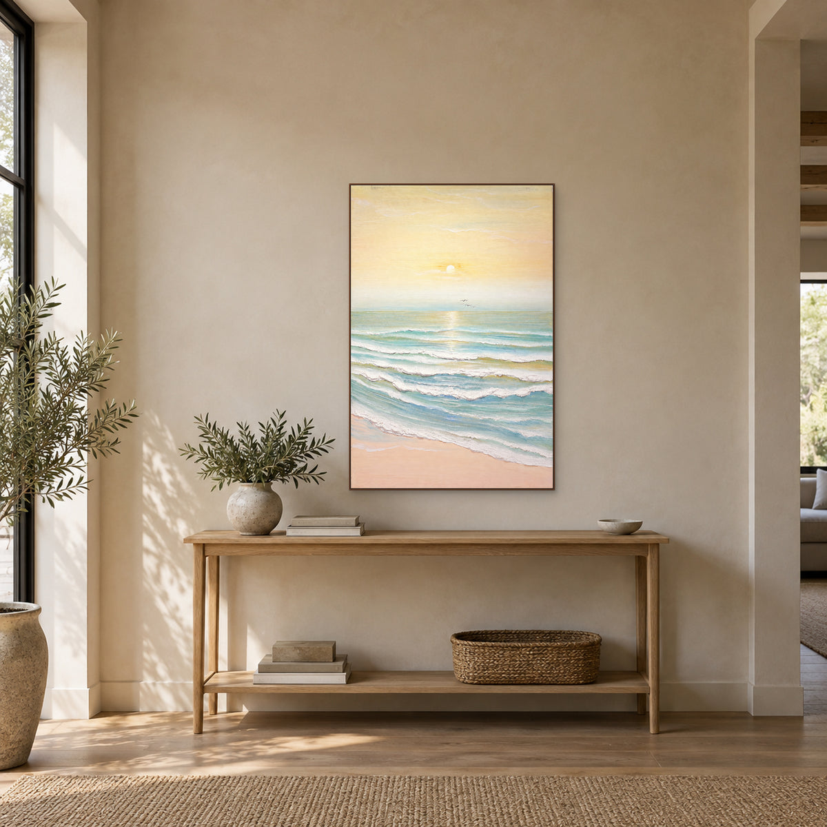 Morning Tide sunrise painting in a walnut-tone floating frame above an entryway console with foliage to the left