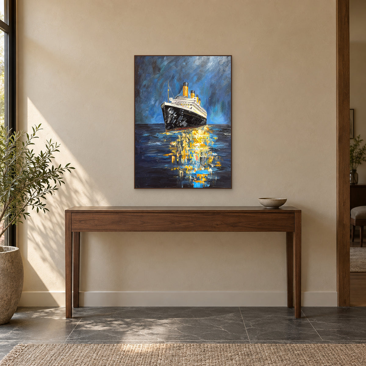 Blue night ship painting in a walnut-toned floating frame above a slim wood console with a low bowl at the right