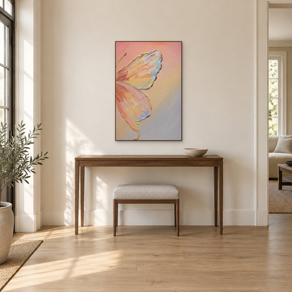 Pastel butterfly in a walnut-tone floating frame above a wooden entryway console