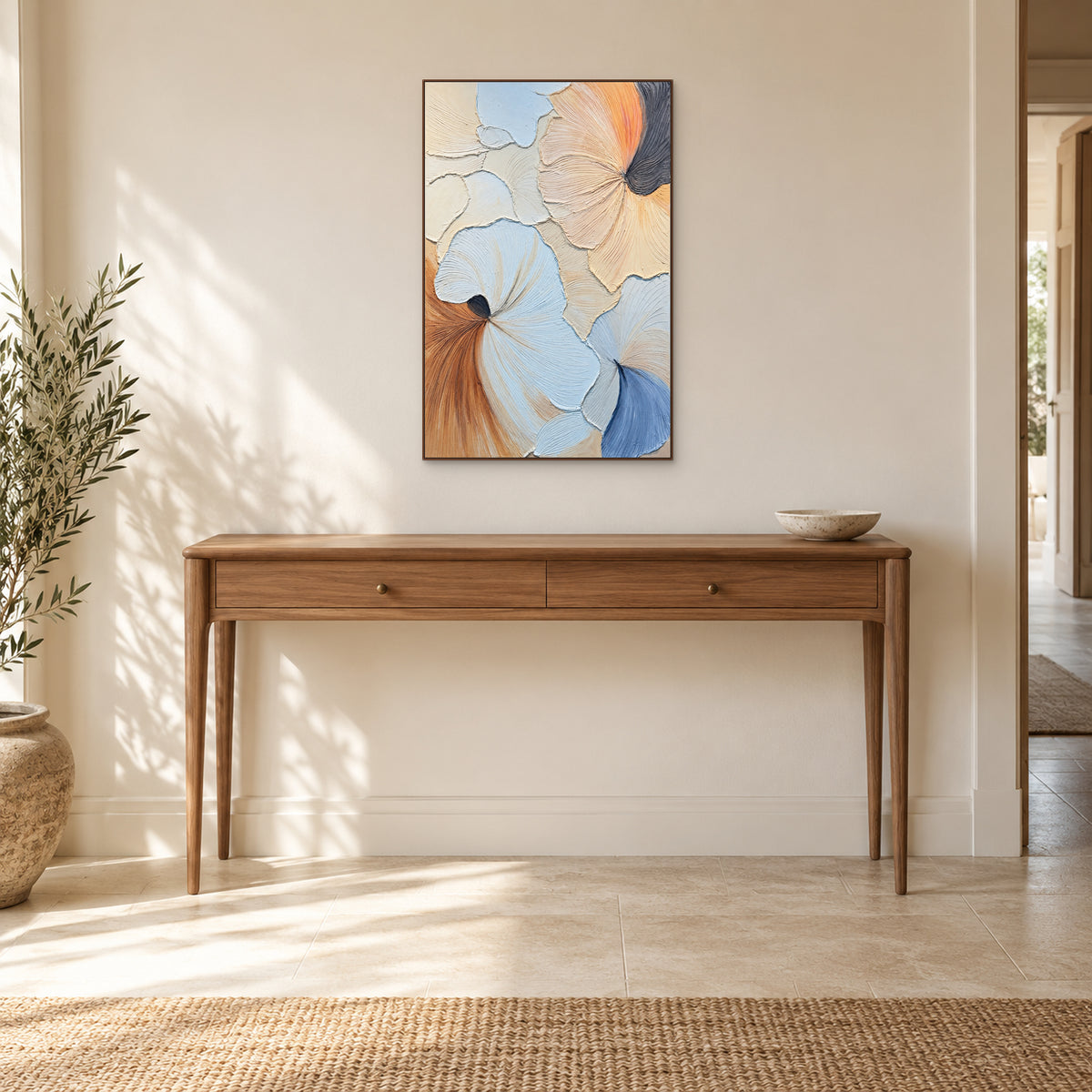 Blue, peach and cream relief painting in a walnut-coloured frame centred above a wooden entryway console