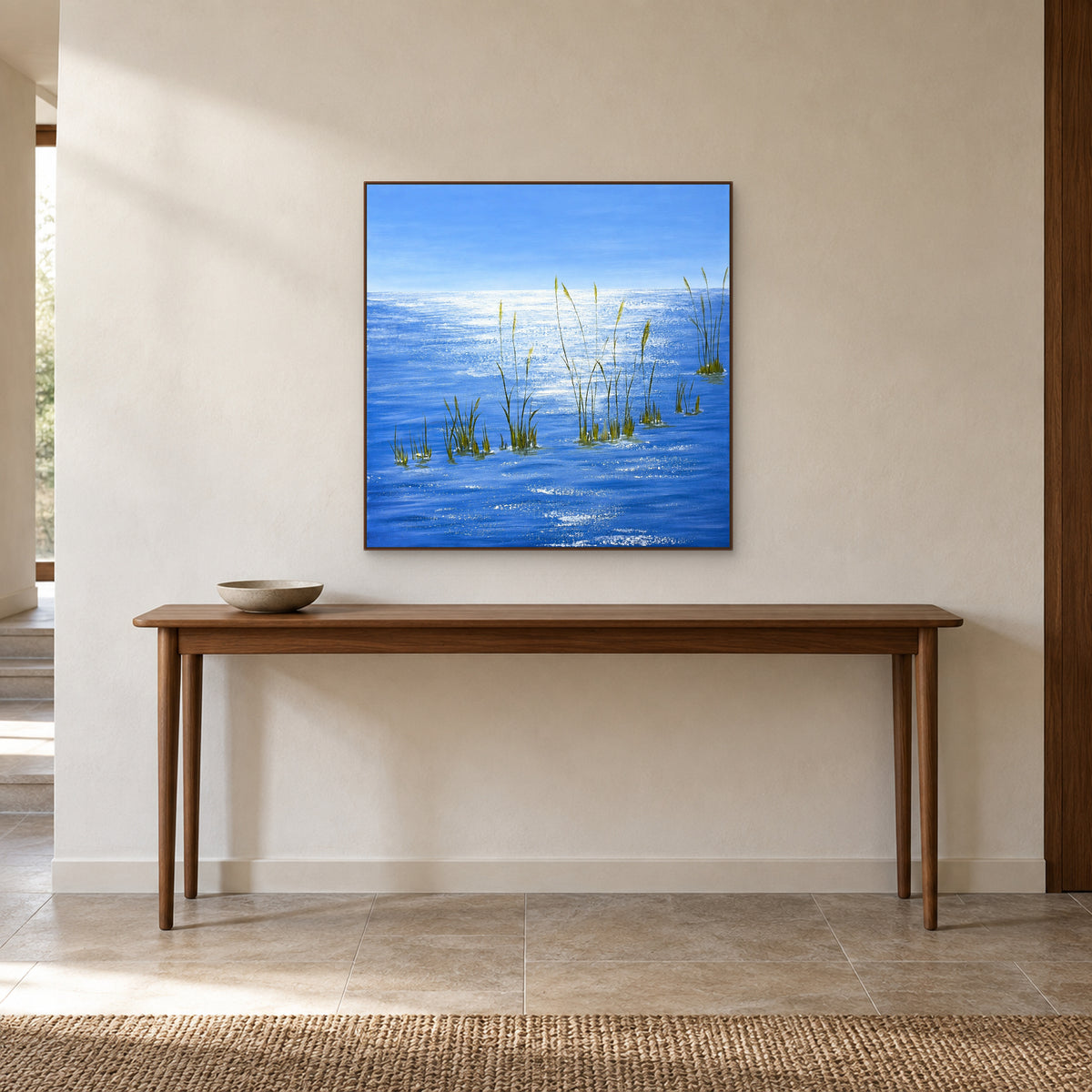 Silver Light on Blue Water in a walnut-tone frame above a slender entryway console