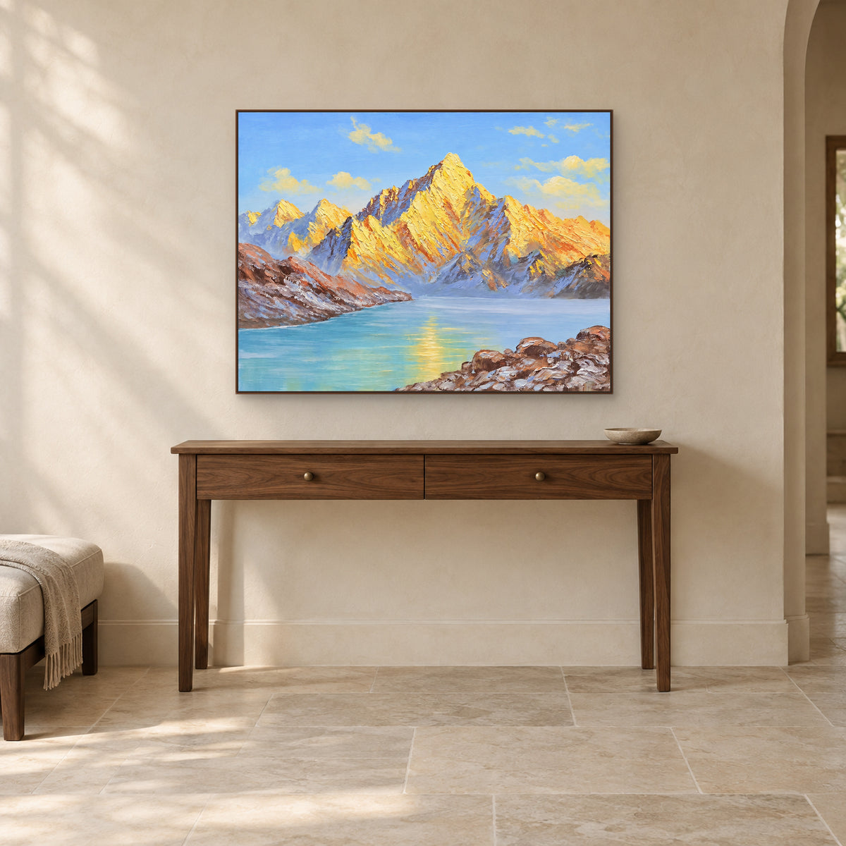 Turquoise lake and sunlit peaks in a walnut-tone frame above a wooden entryway console