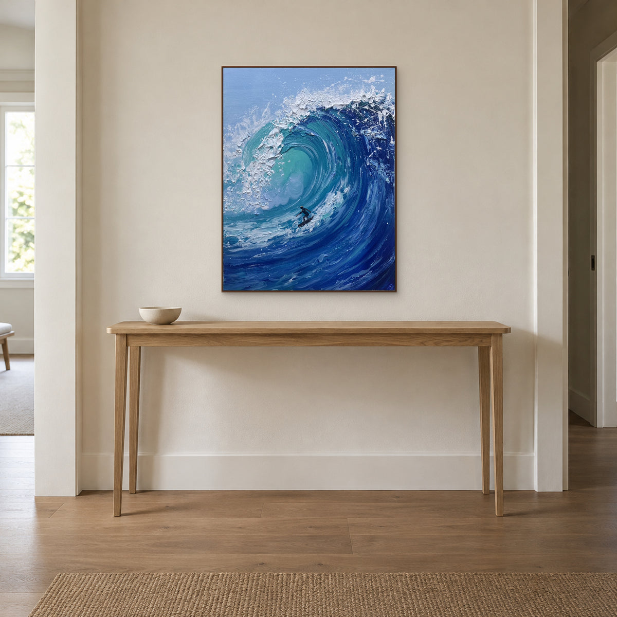 Walnut-tone framed surfer painting centred above a slim wooden entryway console