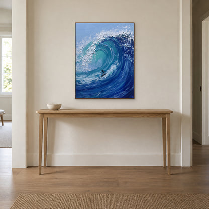 Walnut-tone framed surfer painting centred above a slim wooden entryway console