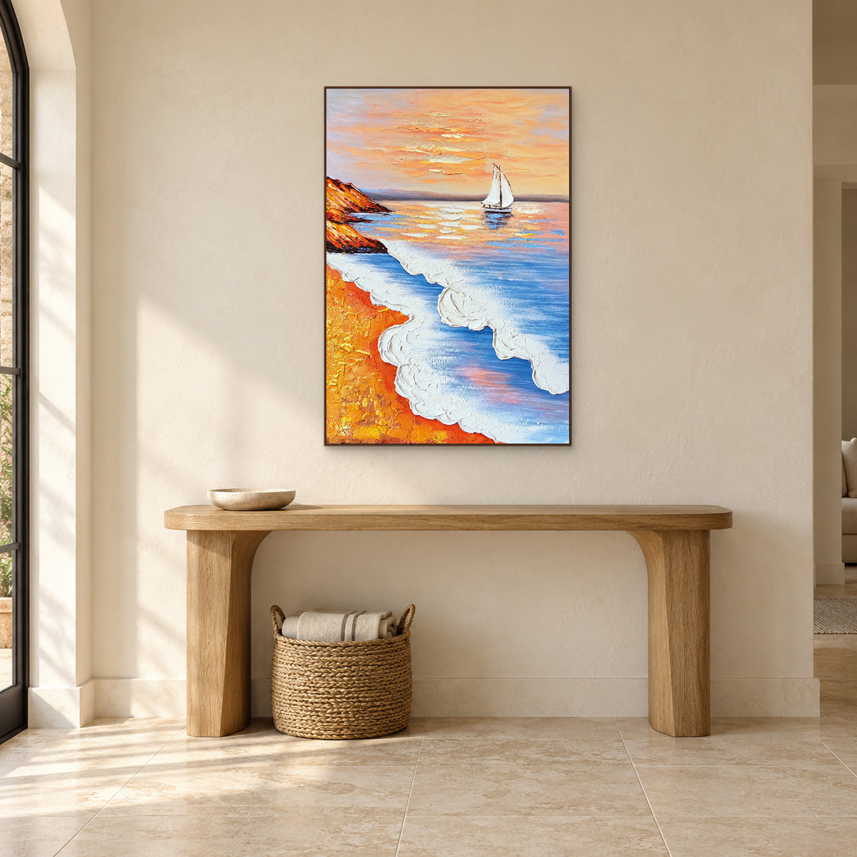 Sailboat seascape in a walnut frame centred over a pale oak console with a shallow bowl and a basket underneath.