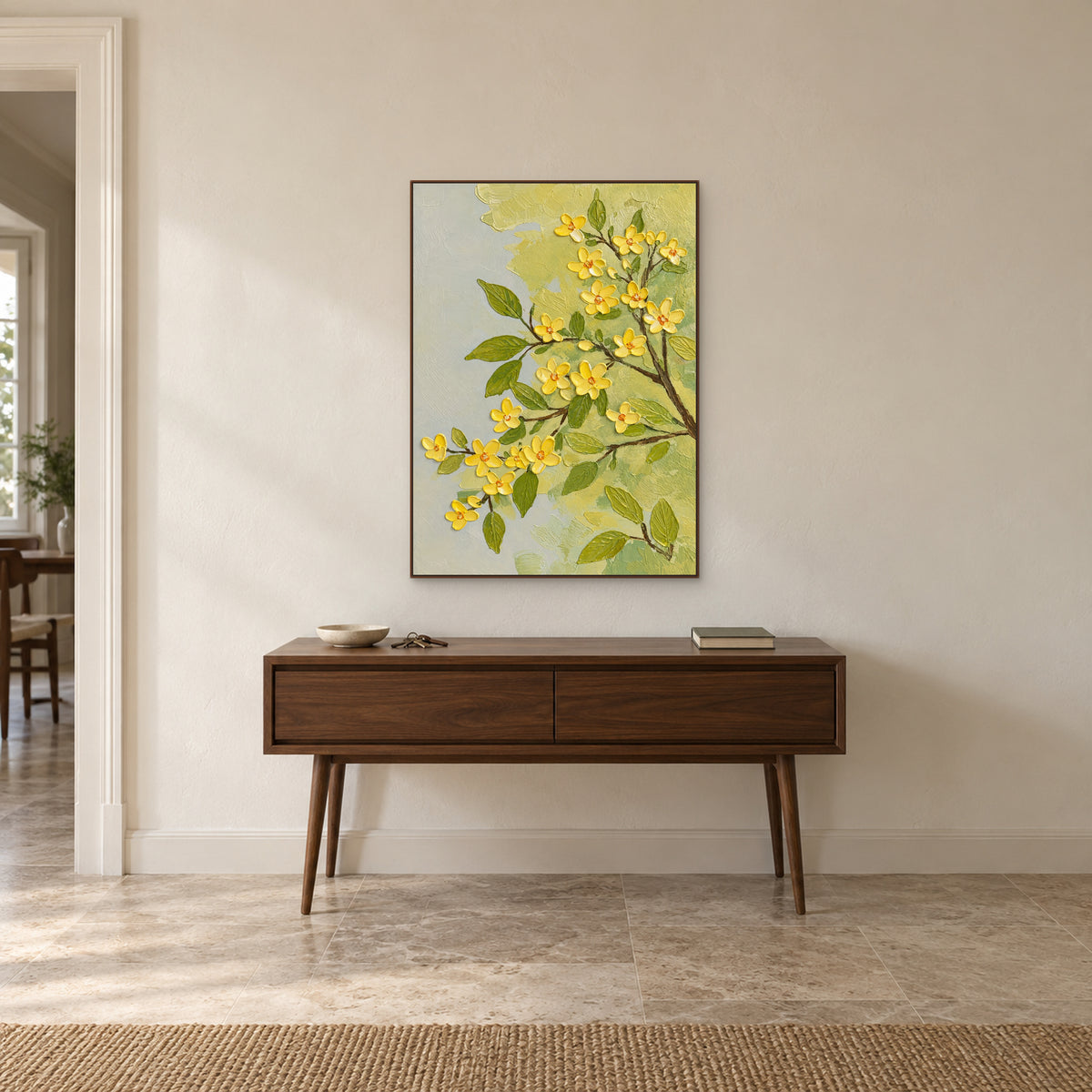 Walnut-tone framed blossom painting above a slim wooden console with a bowl and stacked books