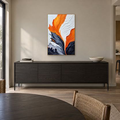 Orange and white textured painting in a champagne-tone frame above a dark sideboard in a dining room