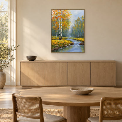 Golden-leaf birches beside a blue cascade, in a champagne-tone frame above an oak dining-room sideboard.