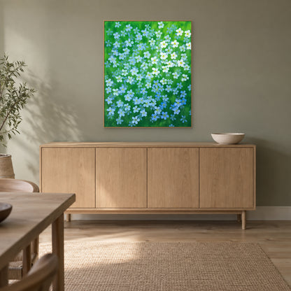 Blue flax botanical painting in a champagne floating frame in a softly lit dining room