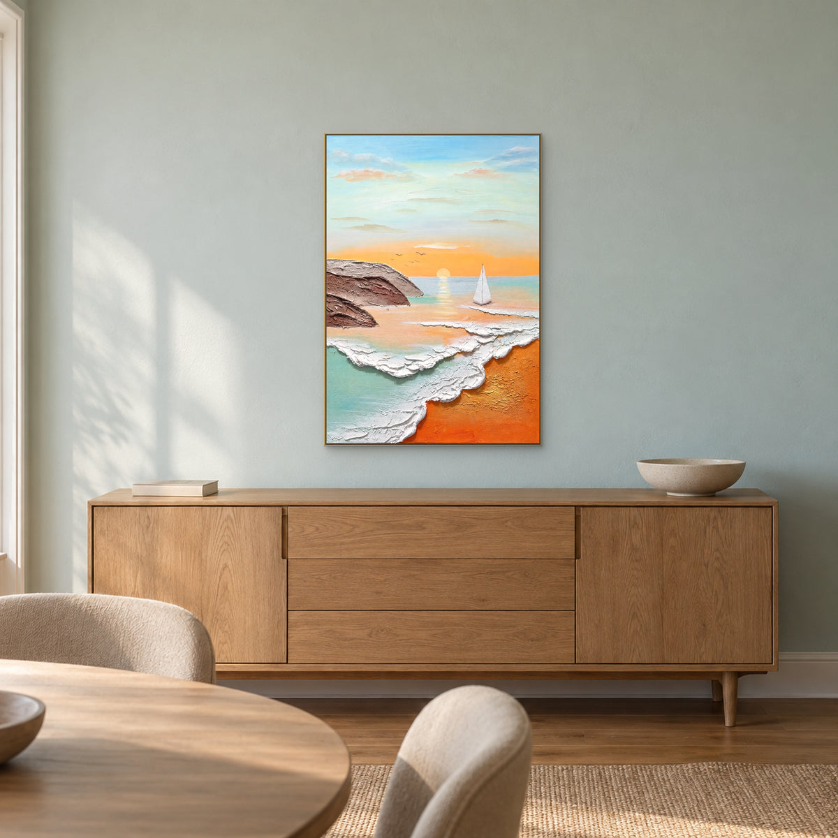 Raised white waves and a dawn sky in a champagne-tone frame above a plain oak-tone dining sideboard