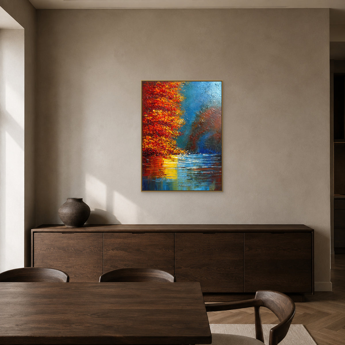 Autumn lake reflection painting in a slim champagne floating frame above a dining-room sideboard