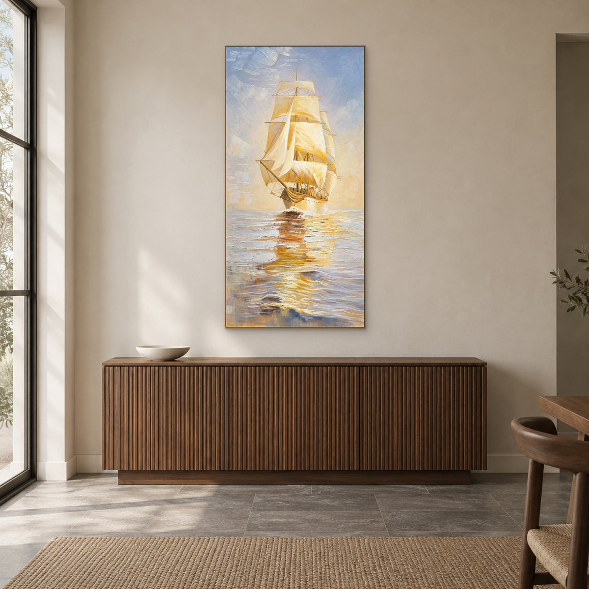 Golden sailing ship painting in a champagne-coloured floating frame above a fluted walnut-toned sideboard.