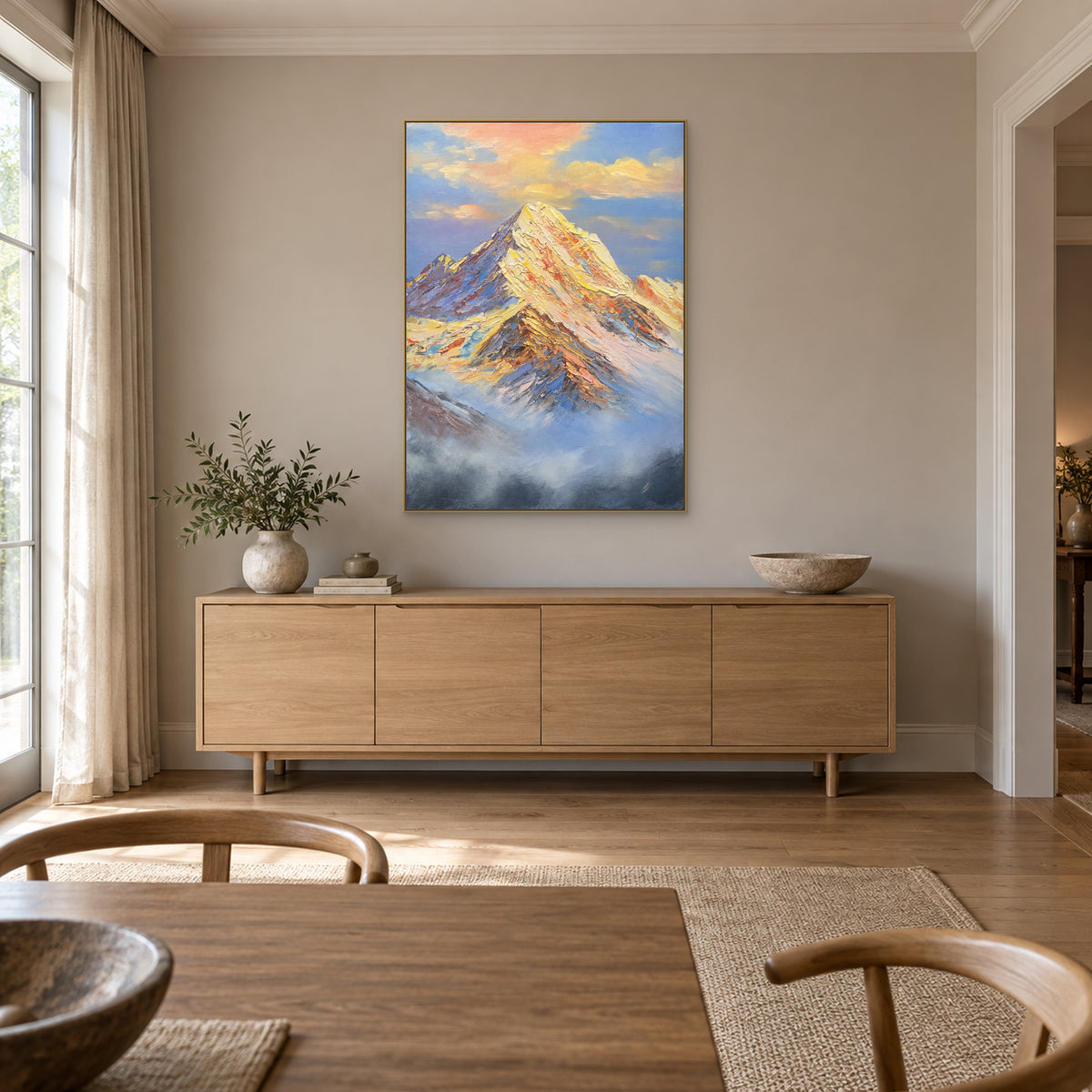 Mountain landscape with blue-grey mist in a champagne-tone frame above a dining-room sideboard