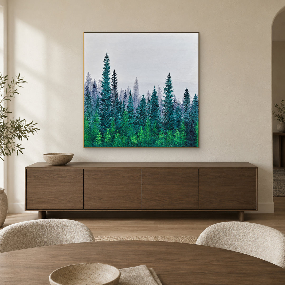 Champagne-framed misty forest above a dark wood sideboard, behind a round dining table