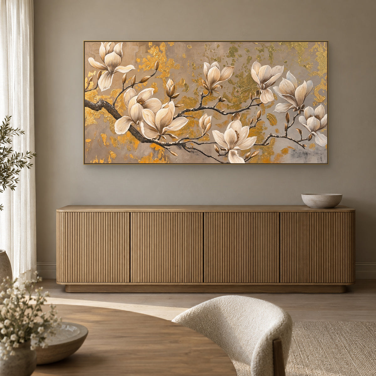 Horizontal magnolia painting in a champagne-coloured frame above a fluted dining-room sideboard