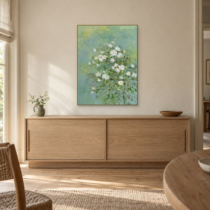 Jasmine floral painting in a champagne-tone frame centred above a light wood sideboard