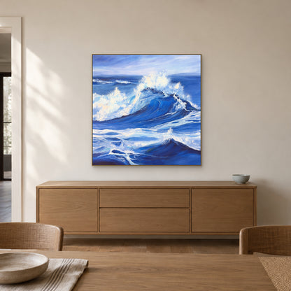 Champagne-framed periwinkle wave painting above an oak sideboard in a quiet dining room