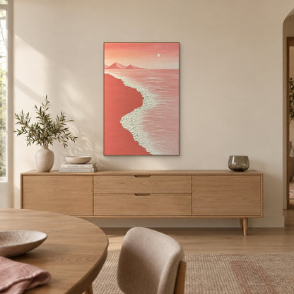 Pink coastal painting in a champagne-tone floating frame above a wooden dining-room sideboard