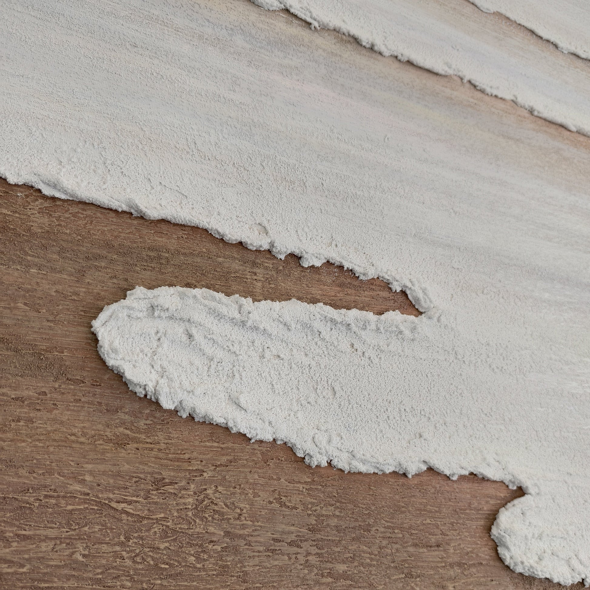 Detail of Eventide Flux ivory surf over warm brown sand