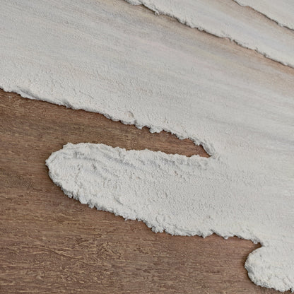 Detail of Eventide Flux ivory surf over warm brown sand