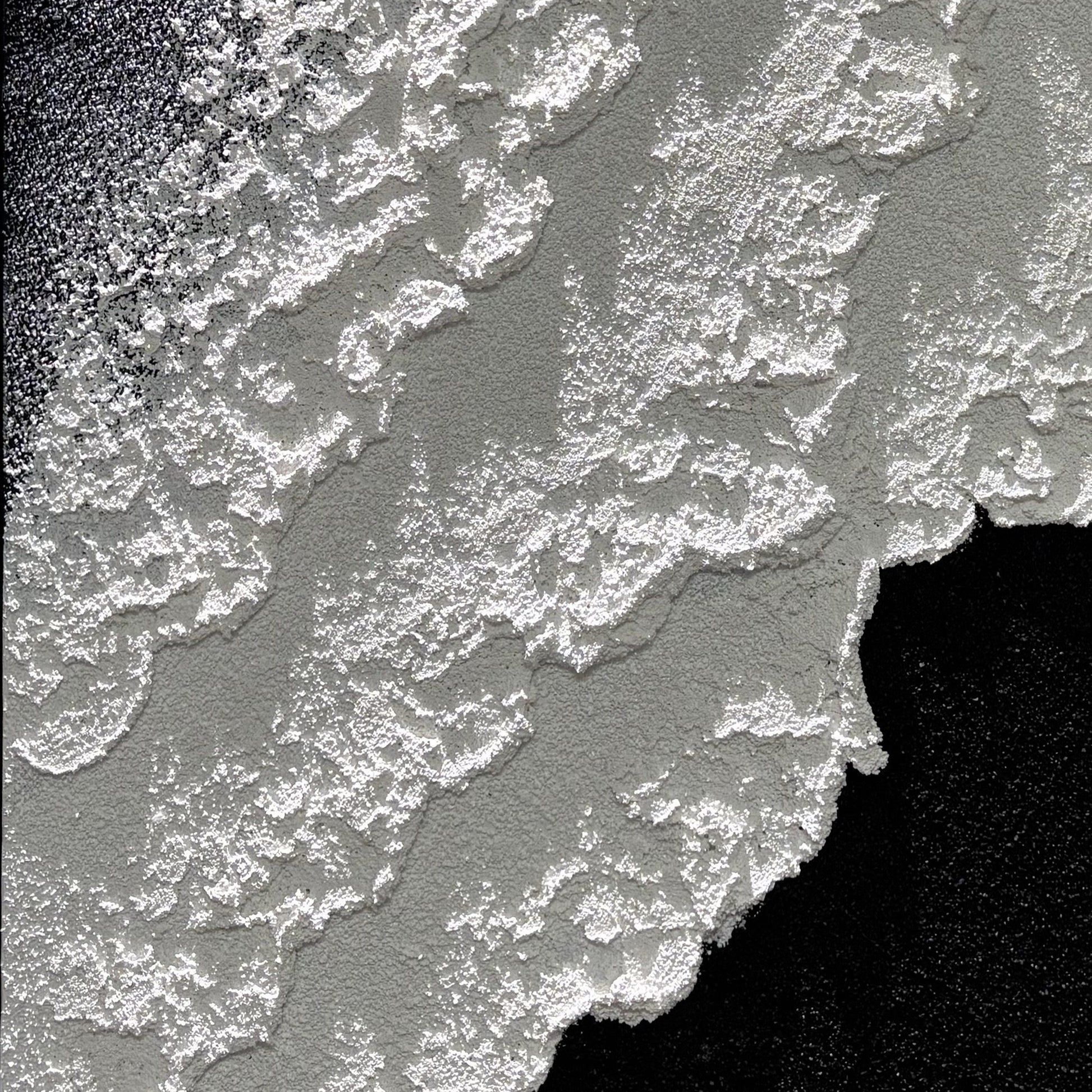 Close view of Vestige of Silence raised edges in directional light
