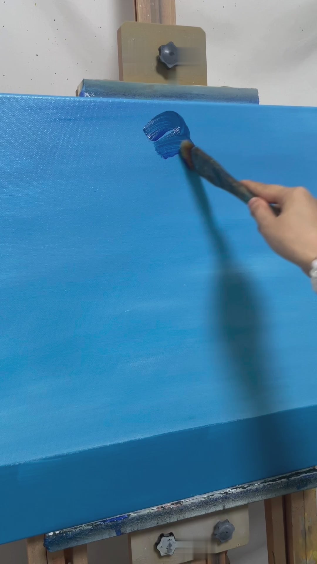 Painting blue clouds, sunrays and scattered sea reflections, followed by the completed horizontal artwork.