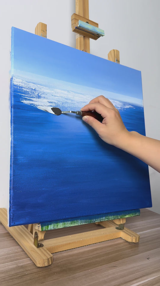 Hand-painting white water reflections and green grasses, followed by the finished blue seascape on an easel