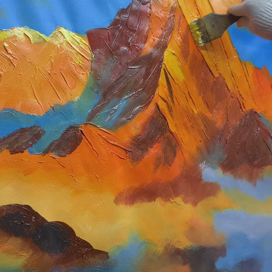 Hand-painting a golden mountain, green meadow and blue wildflowers, followed by the finished landscape and a framed display